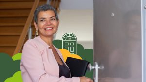 Investor opening the door of a house while holding a clipboard during a property walkthrough