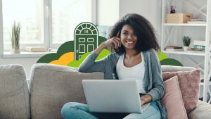 Smiling investor sitting on couch with open laptop, working from home